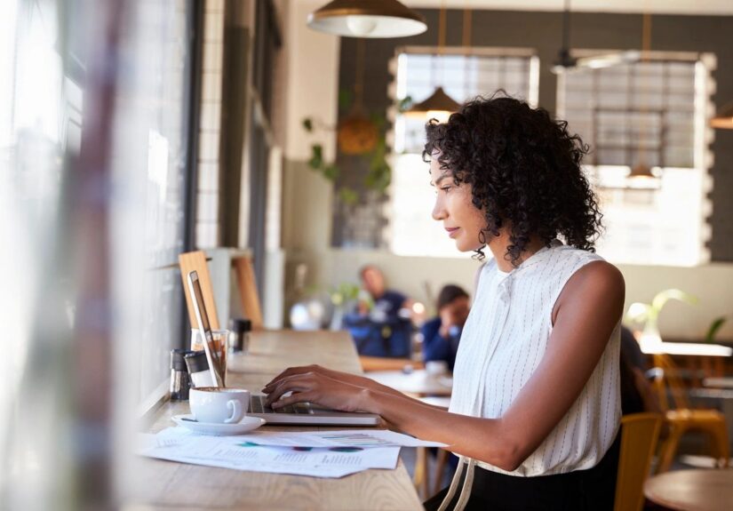 A woman working at a computer in an office setting.
