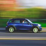 Mini coupe vehicle traveling on road