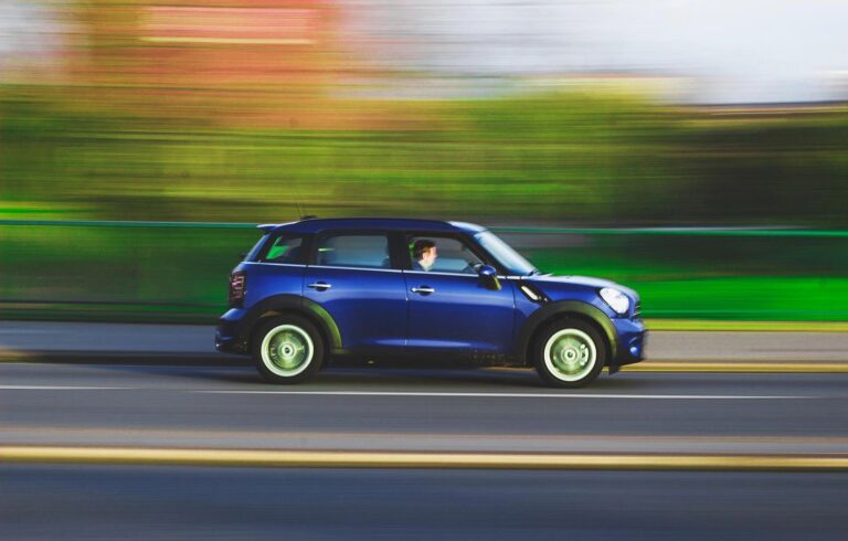 Mini coupe vehicle traveling on road