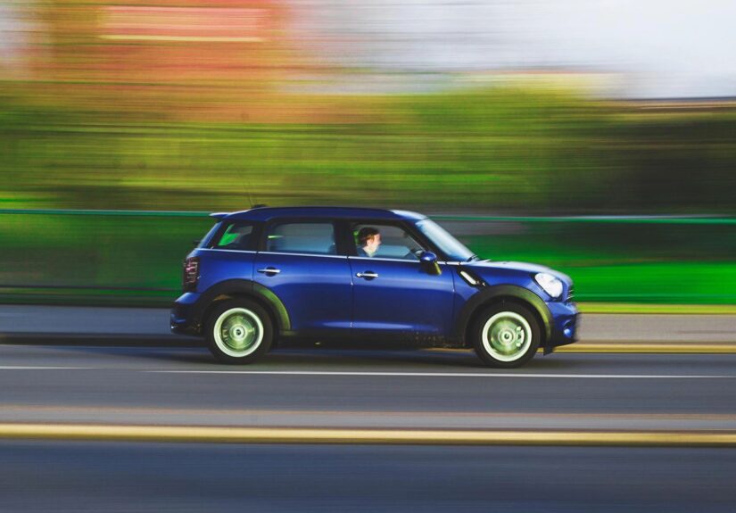 Mini coupe vehicle traveling on road