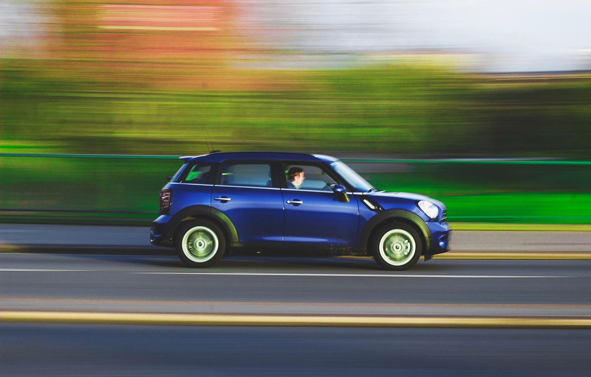 Mini coupe vehicle traveling on road